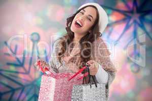 Composite image of happy brunette opening shopping bag