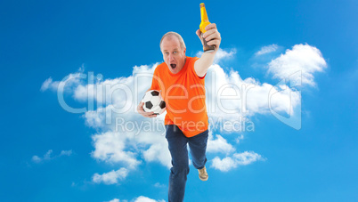 Composite image of mature man in orange tshirt holding football