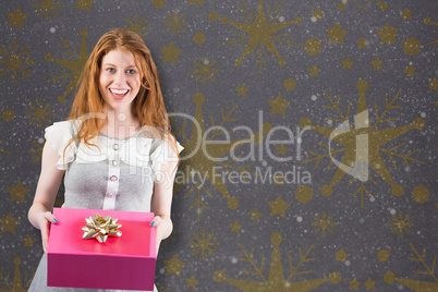 Composite image of pretty redhead offering a gift box