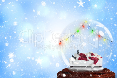 Santa sleeping in snow globe