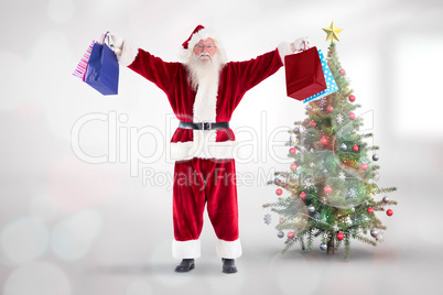 Composite image of santa holds some bags for chistmas