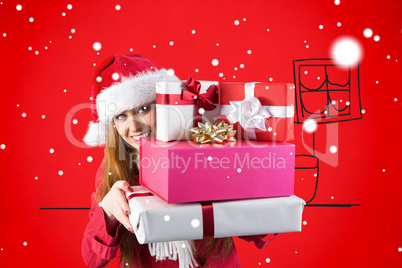 Composite image of festive redhead holding pile of gifts Composite image of festive redhead holding pile of gifts