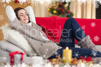 Composite image of brunette napping on the couch at christmas