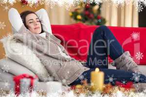 Composite image of brunette napping on the couch at christmas