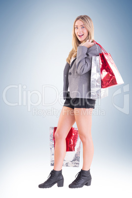 Stylish blonde holding shopping bags