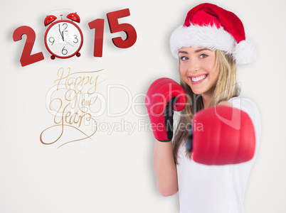 Composite image of festive blonde punching with boxing gloves