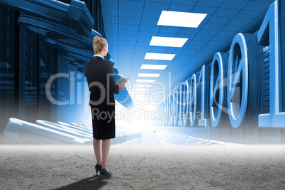 Composite image of businesswoman holding new tablet