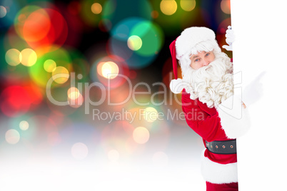 Composite image of smiling santa claus pointing poster