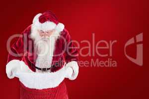 Composite image of santa looks in his bag