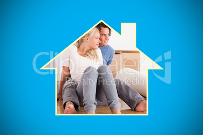 Composite image of lovely couple sitting on the floor