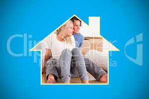 Composite image of lovely couple sitting on the floor