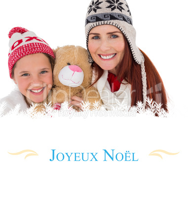 Composite image of mother and daughter holding teddy bear