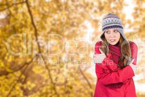 Composite image of cold redhead wearing coat and hat