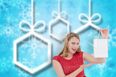 Composite image of smiling woman presenting a shopping bag