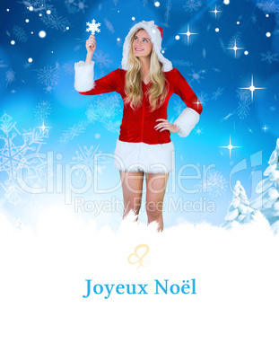 Composite image of pretty girl in santa outfit holding hand up