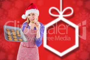 Composite image of festive blonde showing hot cookies