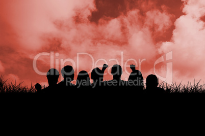 Composite image of silhouettes of football supporters