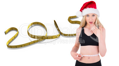 Composite image of fit festive young blonde measuring her waist