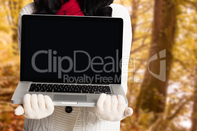 Composite image of woman holding a laptop computer