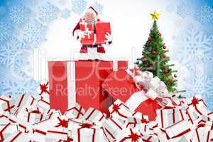 Composite image of santa standing in large gift