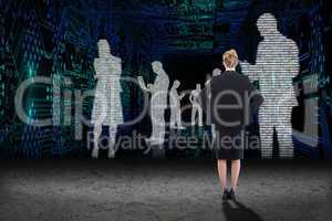 Composite image of businesswoman standing with hands on hips