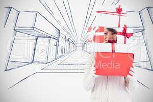 Composite image of festive young woman holding pile of gifts