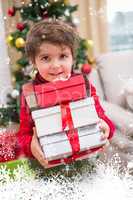 Composite image of cute festive little boy smiling at camera