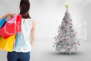 Composite image of rear view of brown hair holding shopping bags