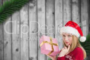 Composite image of woman holding present