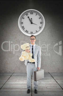 Composite image of businessman holding teddy bear