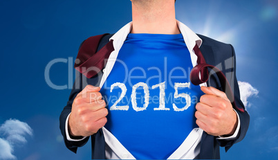 Composite image of businessman opening his shirt superhero style