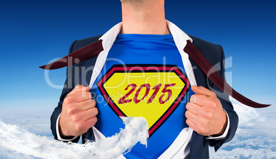 Composite image of businessman opening shirt in superhero style