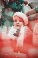 Composite image of cute baby boy in large christmas present