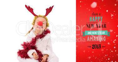 Composite image of cute little girl wearing red nose and tinsel