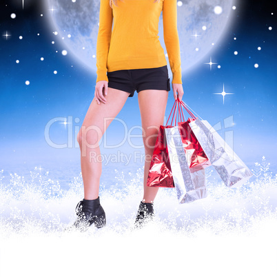 Composite image of stylish woman with shopping bags