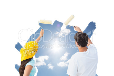 Composite image of happy young couple painting together