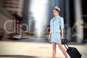 Composite image of pretty air hostess pulling suitcase