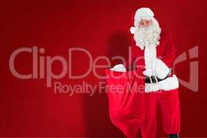 Composite image of smiling santa claus opening sack