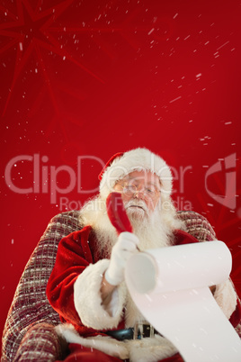 Composite image of father christmas writing list with a quill