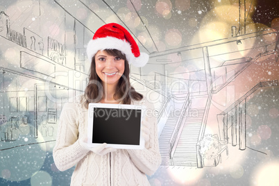 Composite image of festive brunette holding a tablet pc