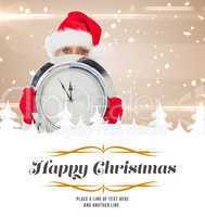 Composite image of festive woman holding clock