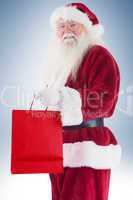 Santa carries red gift bag