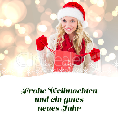 Composite image of happy festive blonde with shopping bag