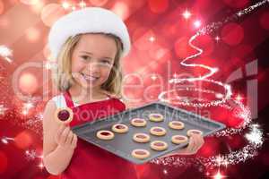Composite image of festive little girl holding fresh cookies
