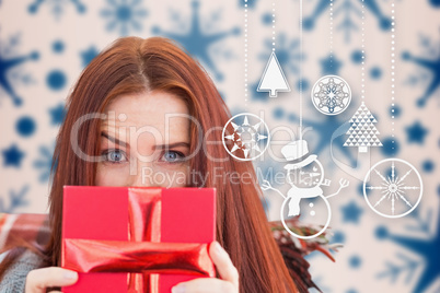 Composite image of woman holding gift