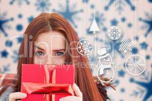 Composite image of woman holding gift