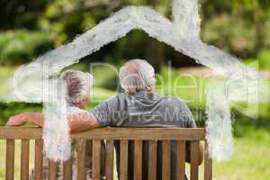 Composite image of couple sitting on the bench with their back t