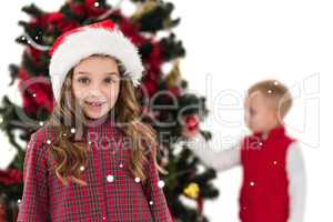 Composite image of festive little girl smiling at camera with bo