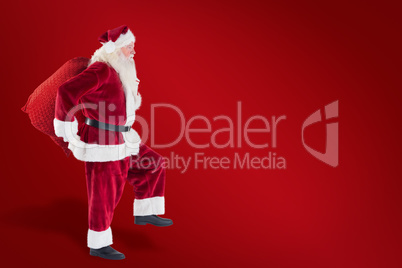 Composite image of santa jumps with his bag