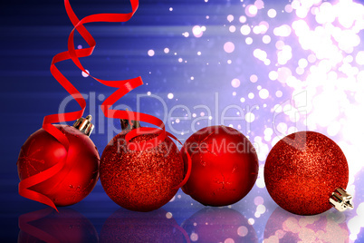Composite image of four red christmas ball decorations